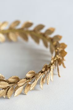 This Roman laurel leaf wreath inspired wedding crown crafted from Swarovski crystals and many high-quality golden leaves. This bridal tiara sparkles from every angle, making sure that all eyes will be in you. Looks stunning worn at weddings, anniversaries and many other special occasions. Measures: adult size. Used materials: Swarovski crystal beads, metal leaves, metal headband. Available colors: Crystal color: * clear crystal * gold crystal (shown) * custom color (ask first) Packed carefully i Greek Golden Leaf Crown, Golden Wreath Crown, Gold Laurel Wreath Crown, Laurel Wreath Aesthetic, Golden Laurel Crown, Golden Leaf Crown, Greek Leaf Crown, Roman Crown, Laurel Leaf Crown