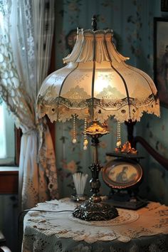 a table with a lamp on top of it next to a wallpapered room