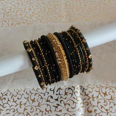 Black silk thread bangles with gold rhinestone silk thread Kada in the centre. You will receive both arms set as shown in the pic. Can be worn on any occasion.   For any specific colours and customisation  just send me a note or a convo.  Kindly note that the actual colours may vary slightly due to computer screen resolution and I truly hope that you do like my handmade products just as much as I love making them. Please note that these are unique designs and made only upon your order. I do not Silk Thread Bangles, Thread Bangles, Stacked Bangles, Gold Thread, Gold Rhinestone, Gold Threads, Fabric Jewelry, Silk Thread, Computer Screen