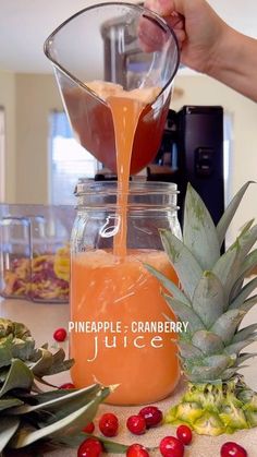 pineapple cranberry juice being poured into a jar