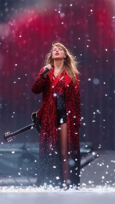 the singer is singing on stage in the snow