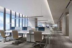 an office with large windows and desks in front of the glass wall that overlooks cityscape