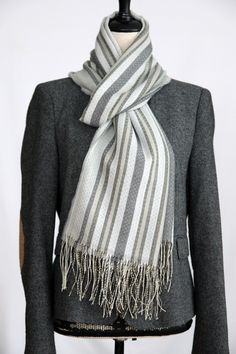 Luxurious alpaca silk scarf - elegance and warmth in one This handmade scarf made from a high-quality blend of 70% alpaca and 30% silk combines luxurious softness with an elegant, subtle sheen. With its subtle shades of grey and white stripes, it is timeless in design and goes perfectly with a variety of outfits - whether casual or chic. The fine shimmer of the silk and the natural warmth of the alpaca make this scarf a must-have for the cold season. This elegant scarf is not only a fashionable Elegant Scarf, Handmade Scarf, Elegant Scarves, Handmade Scarves, Brown Silver, Cold Season, Baby Alpaca, Alpaca Wool, Shawls And Wraps