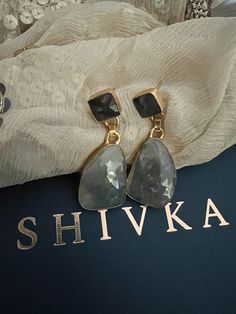 Shivka brings to you a masterful designer piece handcrafted by our skilled Indian craftsmen from Jaipur in brass with natural real gemstones and gold plating. Pick them up and make a statement! The length of the earrings is 5.5 cm. The width of the earrings is 2 cm. This designer jewelry piece can go well with both Indian and western wear. Gold Earrings With Stones For Formal Occasions, Gold Drop Earrings With Stones, Elegant Gold Plated Earrings With Stone Setting, Brass Jewelry With Gemstone Accents For Gift, Elegant Gold-plated Stone Setting Earrings, Elegant Gemstone Danglers For Gift, Gold Plated Danglers Drop Earrings For Gift, Gold Fusion Earrings With Stones, Drop Earrings With Stone Setting For Gift