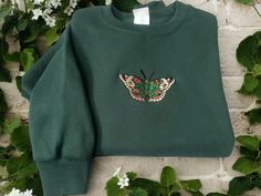 Introducing our exquisite Embroidered Sweatshirt in the enchanting color of dark green. This stunning garment effortlessly combines style with nature-inspired elegance. Adorned with an intricately embroidered butterfly. This sweatshirt captures the beauty of these enchanting creatures. Crafted from premium quality materials, it offers utmost comfort and durability. The dark green hue adds a touch of sophistication, making it ideal for both casual and semi-formal occasions. Perfectly suited for n Embroidered Butterfly, Embroidered Sweatshirts, Fit Inspo, Formal Occasion, Nature Inspired, Semi Formal, The Beauty