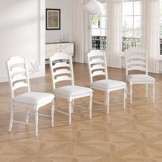 four white dining chairs in an empty room