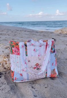 a bag sitting on top of a sandy beach