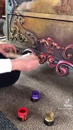 someone is painting the furniture with colorful paint