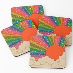 four coasters with colorful sun and clouds on them