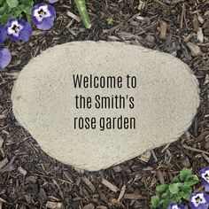 a stone with the words, welcome to the smith's rose garden on it