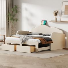 a white bed with two drawers underneath it