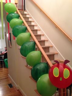 the very hungry caterpillar balloon is going down the stair case in this house