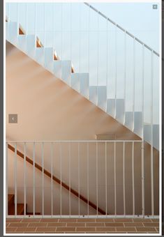 an empty room with white railings and stairs