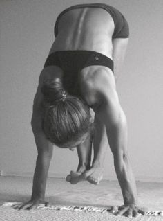 a woman doing a handstand on the floor