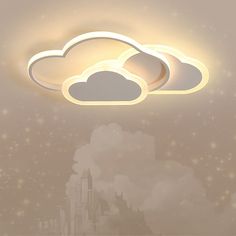 two white clouds floating in the sky above a cityscape with buildings and stars