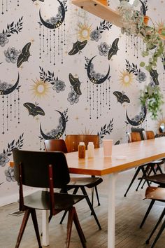 Halloween-themed dining space with witchy wallpaper decorated with moons, bats, and floral elements for a cozy fall setting. Goth Mural, Goth Camper, Moth Wallpaper, Camper Camping, How To Install Wallpaper, Witchy Decor, Standard Wallpaper, Wallpaper Removable, Flowers Wallpaper