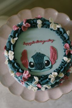 a birthday cake decorated with an image of stitchy