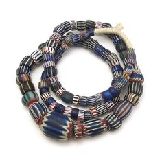 Hand-inlaid glass 7, 6, and 5 Layer Glass Chevron Beads Made in Venice and traded to Mali, West Africa Approx. 38" long Bead size approx. 10mm x 5mm to 30mm x 39mm Traditional Oval Beads Glass Jewelry, Traditional Oval Beaded Glass Jewelry, Traditional Jewelry With Oval Glass Beads, Traditional Glass Single Strand Beaded Necklace, Traditional Single Strand Oval Beads, Traditional Single Strand Beaded Necklace, Traditional Rondelle Single Strand Beads, Glass Spacer Beads In Oval Shape, Traditional Single Strand Rondelle Beads