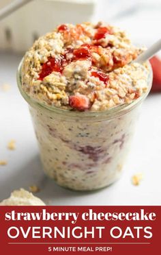 strawberry cheesecake overnight oats in a glass jar with strawberries on the side