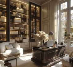 a living room filled with lots of furniture and bookshelves next to large windows