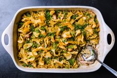 a casserole dish filled with pasta, broccoli and other things in it