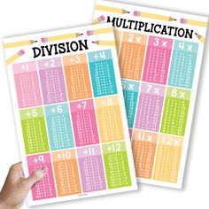 two multicolored calendars with numbers on each one and the word division written in black