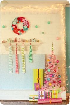 a decorated christmas tree in front of a fireplace