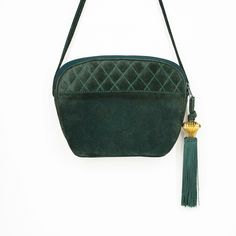 "FREE DOMESTIC SHIPPING! Green genuine suede leather handbag by Nordstrom Made in Italy ERA: vintage 80s SIZE: 7\" tall x 9\" wide (at widest point) x 3.5\" deep COLOR: green (forest, hunter, dark) + gold-tone (metallic, gilded)  HANDLE: suede strap (23\" drop) shoulder crossbody EXTERIOR: genuine suede leather + long gold-tone metal and green tassel accent + quilted stitching in diamond pattern INTERIOR: fully lined + 1 zip pocket HARDWARE: zip closure CONDITION: This vintage bag has distressed over time and shows natural signs of wear. It is in good vintage condition overall. Please look closely at photos for details and contact me with questions. FUNCTION: handbag, purse, shoulder, crossbody, carryall STYLE: retro, preppy, minimalist, classic, versatile, structured, chic, mid century, g Cheap Green Shoulder Bag With Gold-tone Hardware, 80s Purse, Forest Hunter, Hunters Gold, Pattern Interior, Retro Preppy, Handbag Vintage, Green Forest, Quilt Stitching