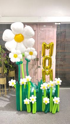 balloon flowers in the shape of letters and daisies are on display at an event