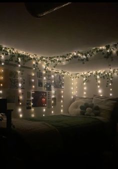 a bedroom with lights strung from the ceiling