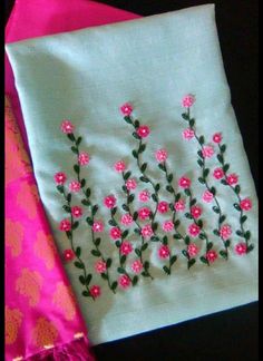 two pieces of cloth with embroidered flowers on them