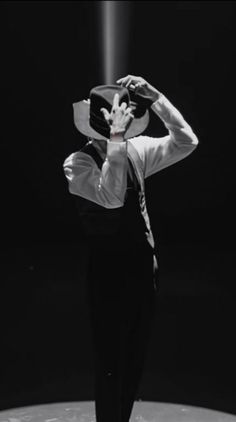 a man wearing a hat standing on top of a moon