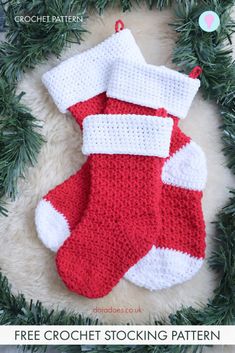 a crocheted christmas stocking hanging from a wreath on top of a rug