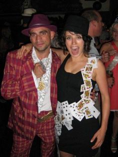 a man and woman dressed up in costume at a casino party, posing for the camera