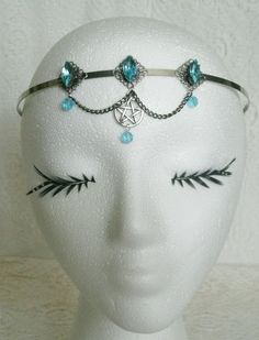 Blue Pentacle Circlet This beautiful circlet has three sterling silver plated filigree accents with aqua blue faceted glass settings, aqua blue glass bead drops, pewter silver pentacle and metal chain. An elegant headpiece. Adjustable. Adjustable Fantasy Jewelry For Festivals, Adjustable Fantasy Festival Jewelry, Fantasy Metal Body Jewelry For Festival, Silver Fantasy Jewelry For Festivals, Adjustable Gothic Jewelry For Festivals, Gothic Adjustable Body Jewelry For Festivals, Gothic Blue Metal Jewelry, Blue Gothic Metal Jewelry, Fantasy Crown-shaped Jewelry Gift