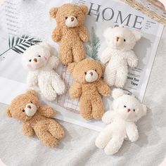 six stuffed teddy bears sitting on top of a table next to a newspaper and plant