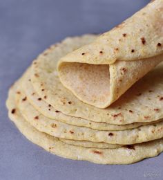 a stack of tortillas sitting on top of a table