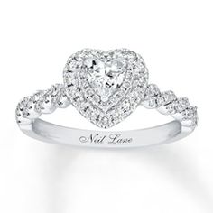 a heart shaped diamond ring with diamonds on the band and an inscription that says, love is