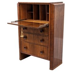 an old fashioned wooden desk with drawers on the top and bottom shelf, which is open to reveal its contents