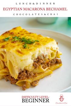 a white plate topped with lasagna and cheese