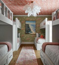 a room with bunk beds, rugs and paintings on the wall in it's center