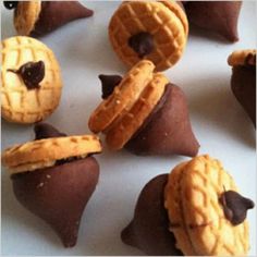 some cookies and chocolates are arranged on a white plate with holes in the middle