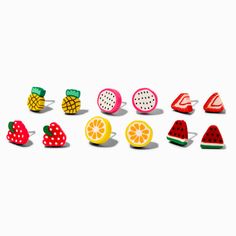 a group of fruit shaped pins sitting on top of each other in front of a white background