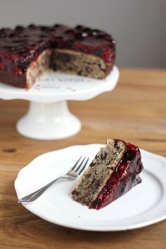 a piece of cake on a plate with a fork next to it and another slice missing