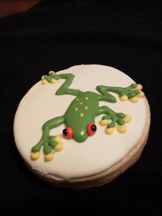 a decorated cake with a green frog on it