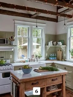 a large kitchen with lots of counter space and open windows on the wall above it