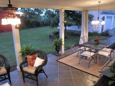 a covered patio with chairs and tables on it