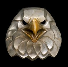 an eagle's head made out of metal on a black background with the words american in gold