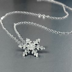 Hand formed Snowflake pendant in solid sterling silver. This snowflake is just over 5/8 inch (17mm) on a lacy sterling silver curb link chain. Choose 16 or 18 inches. The mannequin is Life Size to show the actual scale of the necklace. Pictured is the 16 inch chain I also make a ring with the same snowflake design in a slightly smaller size; https://www.etsy.com/listing/171287395/snowflake-ring-in-sterling?ref=shop_home_active_4&frs=1 Winter White Sterling Silver Necklaces, Sterling Silver Necklace For Winter, Winter Sterling Silver Necklace, Snowflake Ring, Snowflake Necklace, Snowflake Pendant, Snowflake Design, Silver Snowflakes, Snowflake Designs