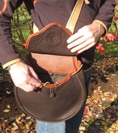 a man holding a brown purse in his hands